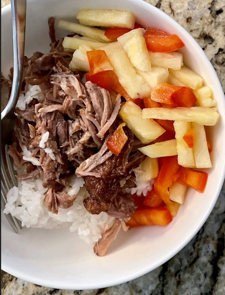 Bowl of rice, carnitas, pineapple and red pepper